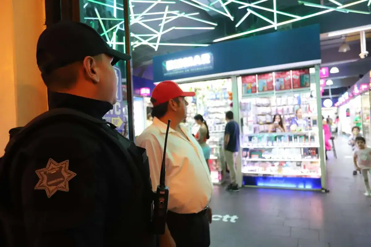 Vigilante de seguridad en shopping center con luces de neón.